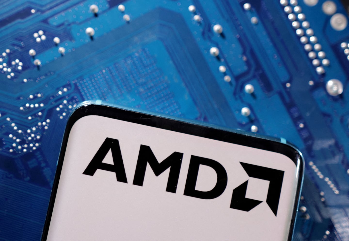 FILE PHOTO: A smartphone with a displayed AMD logo is placed on a computer motherboard in this illustration taken March 6, 2023. REUTERS/Dado Ruvic/Illustration/File Photo