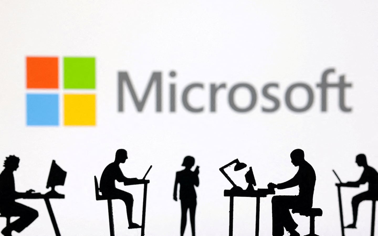 FILE PHOTO: Figurines with computers and smartphones are seen in front of Microsoft Corporation logo in this illustration taken, February 19, 2024. REUTERS/Dado Ruvic/Illustration/File Photo