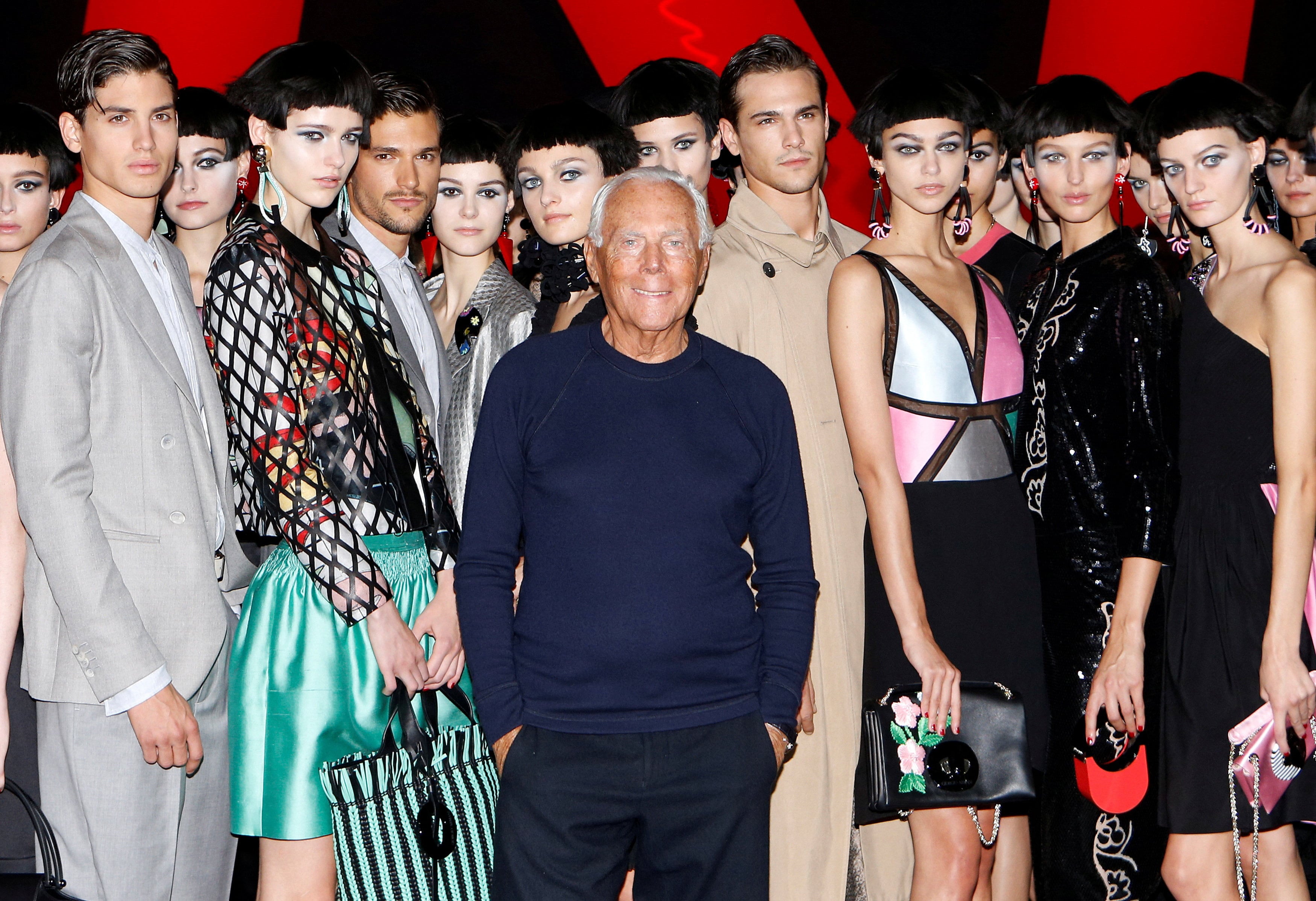 FILE PHOTO: Italian designer Giorgio Armani poses with models at the end of his Spring/Summer 2018 show at the Milan Fashion Week in Milan, Italy, September 22, 2017.  REUTERS/Alessandro Garofalo/File Photo