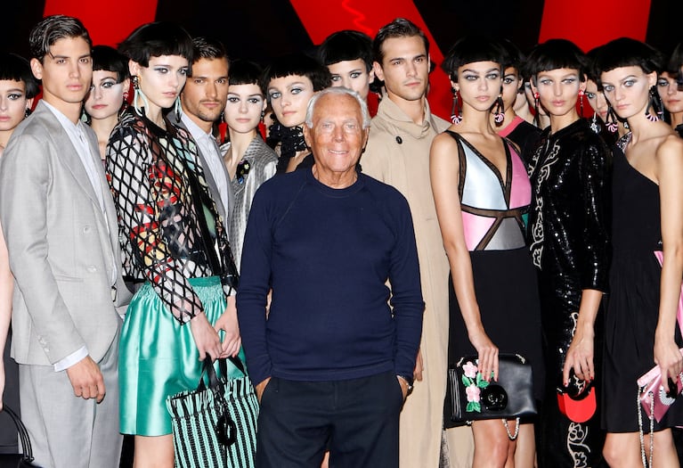FILE PHOTO: Italian designer Giorgio Armani poses with models at the end of his Spring/Summer 2018 show at the Milan Fashion Week in Milan, Italy, September 22, 2017. REUTERS/Alessandro Garofalo/File Photo