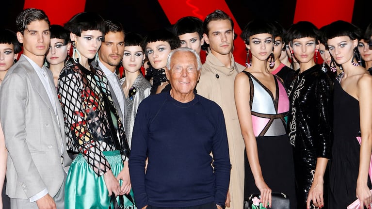 FILE PHOTO: Italian designer Giorgio Armani poses with models at the end of his Spring/Summer 2018 show at the Milan Fashion Week in Milan, Italy, September 22, 2017. REUTERS/Alessandro Garofalo/File Photo