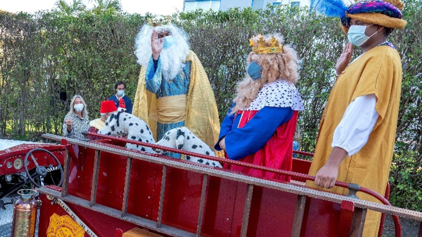 Los Reyes Magos llegan en un antiguo camión de bomberos. Foto: EFE.