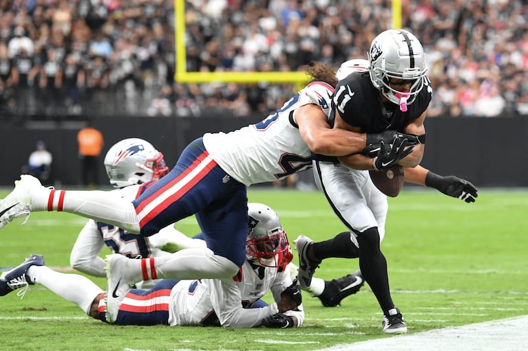 Oct 15, 2023; Paradise, Nevada, USA; Las Vegas Raiders wide receiver Tre Tucker (11) is tackled by New England Patriots linebacker Jahlani Tavai (48) in the first quarter at Allegiant Stadium. Mandatory Credit: Candice Ward-USA TODAY Sports