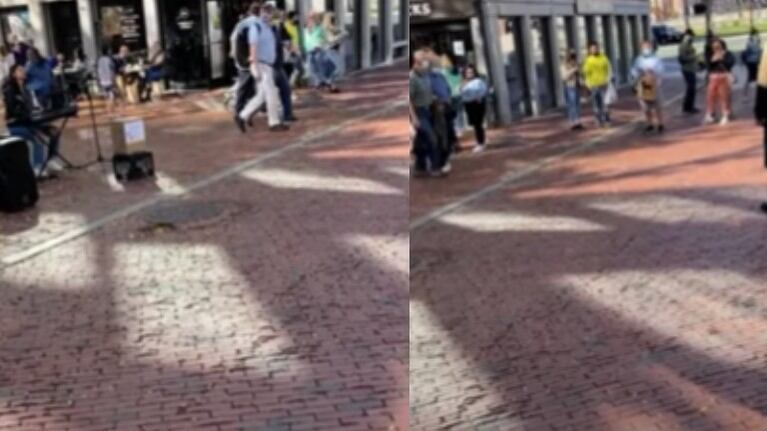 Una artista callejera interpreta una canción de John Legend para John Legend en una calle de Boston