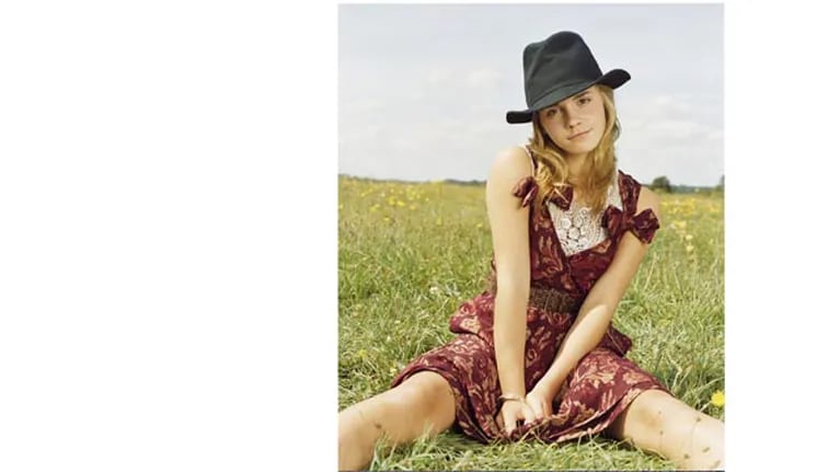 ca. 2005 --- Wool and silk dres by Moschino Cheap & Chic, Viscose-spandex-blend top by Kenziegirl, wool hat by Y's Yohji Yamamata, metallic belt by Beyond Retro, gold bangles by Isaac Manevitz for Ben-Amur. --- Image by Â© Viki Forshee/Corbis Outline